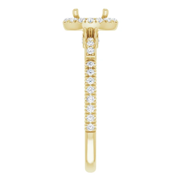 This vintage halo engagement ring setting is designed to hold a 6.5mm round center stone. Featuring intricate scrollwork details and a pave diamond band, this elegant mounting is available in 18K gold. Ideal for custom engagement jewelry.