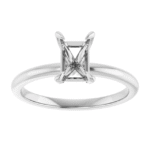 This solitaire ring mounting is designed to hold a 7x5 mm emerald-cut center stone, showcasing clean geometry and timeless elegance. The sharp lines and elongated shape of the emerald cut highlight the ring’s modern minimalist structure. Although understated, the design draws attention with its symmetry and balance. Moreover, its proportion fits comfortably on the finger, making it a versatile base for lab-grown or natural stones.