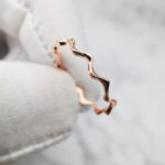 Discover this solid gold wavy band ring, perfect for custom fine jewelry lovers seeking one-of-a-kind, made-to-order engagement and wedding rings.