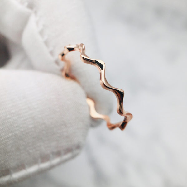 Discover this solid gold wavy band ring, perfect for custom fine jewelry lovers seeking one-of-a-kind, made-to-order engagement and wedding rings.
