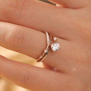 This Nature Inspired Lab Diamond Engagement Ring features a graceful branch design embracing a brilliant round cut lab-grown diamond, capturing the beauty of the natural world. We offer various metal options including 925 sterling silver, 9K/10K/14K/18K gold, and PT950 platinum. Gemstone customization is available, allowing you to choose from lab-grown diamonds, moissanite, cubic zirconia, natural diamonds, or colored gemstones. We also provide engraving services and support custom designs from images. Our professional design team will work closely with you to transform your vision into a one-of-a-kind custom engagement ring.
