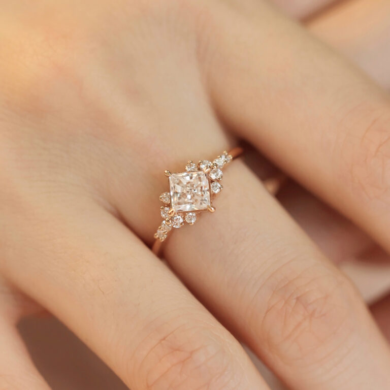 This princess cut lab diamond cluster engagement ring masterfully blends modern elegance with classic sophistication. In addition, as a made-to-order engagement jewelry piece, it offers you the flexibility to customize the arrangement of lab-grown diamonds to match your taste. Whether you prefer a minimalist cluster or a more intricate design, we collaborate closely with you throughout the process, so that the final piece truly becomes personalized fine jewelry tailored to your vision and lifestyle.