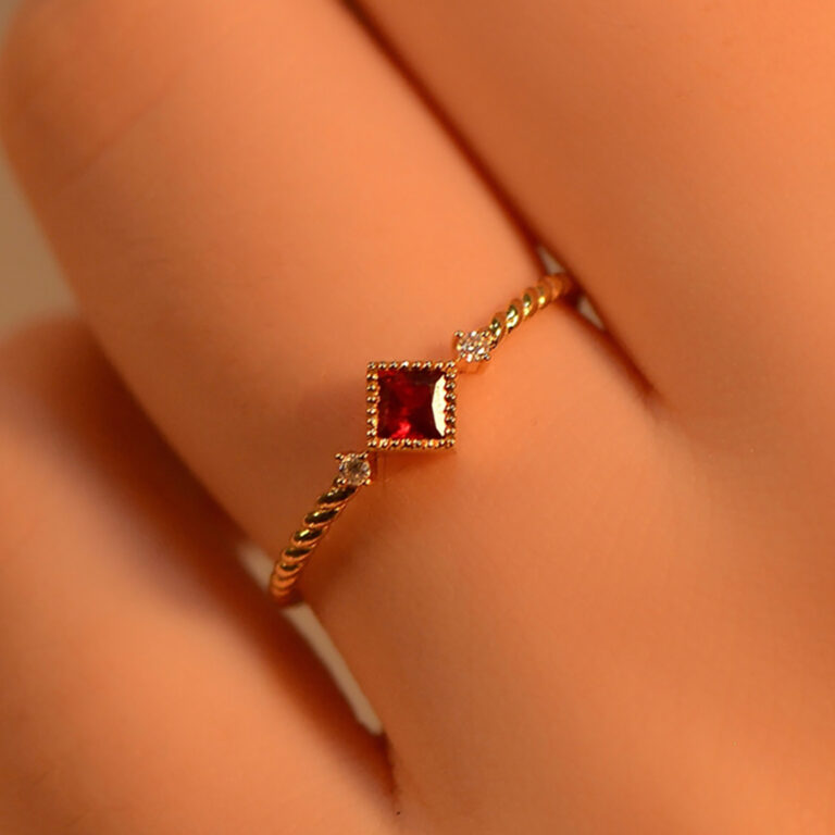 This princess cut ruby engagement ring is crafted with a lab-created ruby gemstone and paired with a minimalist solid gold twist band. In addition, clients can personalize the band width, finish, or even upgrade to different metal options such as white or rose gold. Whether you prefer a bold statement or a subtle, refined design, this ruby twist band ring can be tailored to reflect your style. Furthermore, check out our Custom Rings Page for options or explore our Wedding Bands Collection for matching sets.
