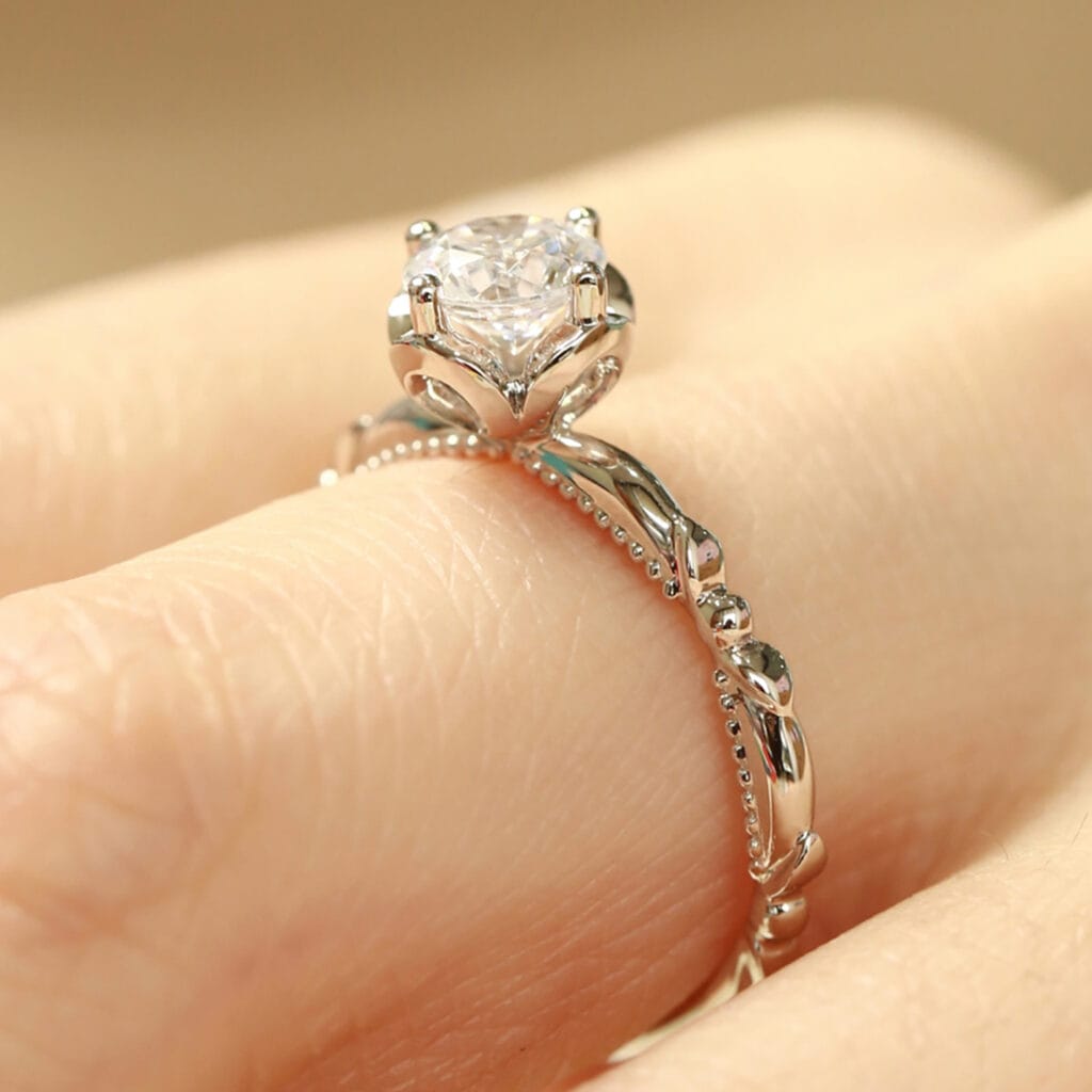 Lab diamond flower engagement ring worn on the hand