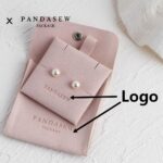 Custom microfiber suede jewelry packaging with logo customization. Available in pink, gray, and gray blue. Soft suede-like texture, durable, 100pcs MOQ.