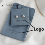 Custom microfiber suede jewelry packaging with logo customization. Available in pink, gray, and gray blue. Soft suede-like texture, durable, 100pcs MOQ.