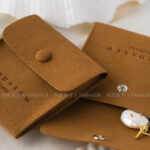 This custom logo jewelry pouch is created for jewelry brands, designers, and studios seeking dependable packaging solutions. It supports both small-batch and bulk orders, making it suitable for emerging brands as well as established businesses. Whether used as a primary packaging piece or as inner protection within a jewelry box, the pouch offers reliable storage and polished presentation. Its secure closure, refined texture, and customization flexibility make it a practical choice for long-term jewelry packaging strategies.