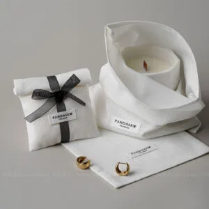 This custom logo jewelry pouch is a practical packaging solution designed for jewelry brands that value simplicity, consistency, and everyday usability. Made from soft cotton fabric, it provides a clean and reliable way to store and protect jewelry pieces such as rings, earrings, bracelets, and necklaces. Rather than acting as decorative packaging, this pouch focuses on function, brand clarity, and efficient order fulfillment across retail and online channels.