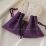 Custom microfiber ingot pouch made from light-colored soft suede. It is designed for jewelry brands seeking unique, professional, and protective packaging solutions with a 100-piece MOQ.