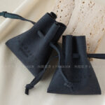 Custom microfiber ingot pouch made from light-colored soft suede. It is designed for jewelry brands seeking unique, professional, and protective packaging solutions with a 100-piece MOQ.