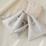 Custom microfiber ingot pouch made from light-colored soft suede. It is designed for jewelry brands seeking unique, professional, and protective packaging solutions with a 100-piece MOQ.