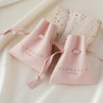 Custom microfiber ingot pouch made from light-colored soft suede. It is designed for jewelry brands seeking unique, professional, and protective packaging solutions with a 100-piece MOQ.