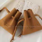 Custom microfiber ingot pouch made from light-colored soft suede. It is designed for jewelry brands seeking unique, professional, and protective packaging solutions with a 100-piece MOQ.