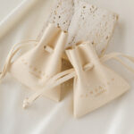 Custom microfiber ingot pouch made from light-colored soft suede. It is designed for jewelry brands seeking unique, professional, and protective packaging solutions with a 100-piece MOQ.