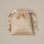 This custom faux sheepskin pouch features a soft suede texture and a vibrant finish. It provides an elegant storage solution for jewelry branding.