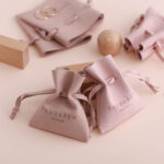 This custom microfiber ingot pouch features a unique ingot shape. It provides a soft, elegant, and secure storage solution for professional jewelry branding with a 100pc MOQ.