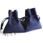 This custom microfiber ingot pouch features a unique ingot shape. It provides a soft, elegant, and secure storage solution for professional jewelry branding with a 100pc MOQ.