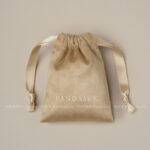 This custom faux sheepskin pouch features a soft suede texture and a vibrant finish. It provides an elegant storage solution for jewelry branding.