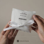 This custom white cotton pouch features a clean design and a soft drawstring closure. It provides an organic storage solution for jewelry branding.