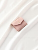 This custom folding jewelry pouch features a snap button and organized interior. It provides an elegant storage solution for jewelry branding.