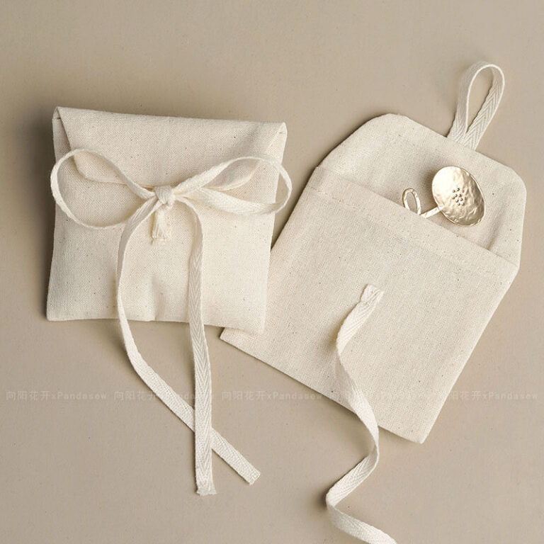 This custom cotton envelope pouch features a unique string tie and soft fabric. It provides a natural and secure solution for jewelry branding.