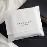 This custom cotton envelope pouch features a sleek design and soft fabric. It provides a natural and secure solution for jewelry branding.