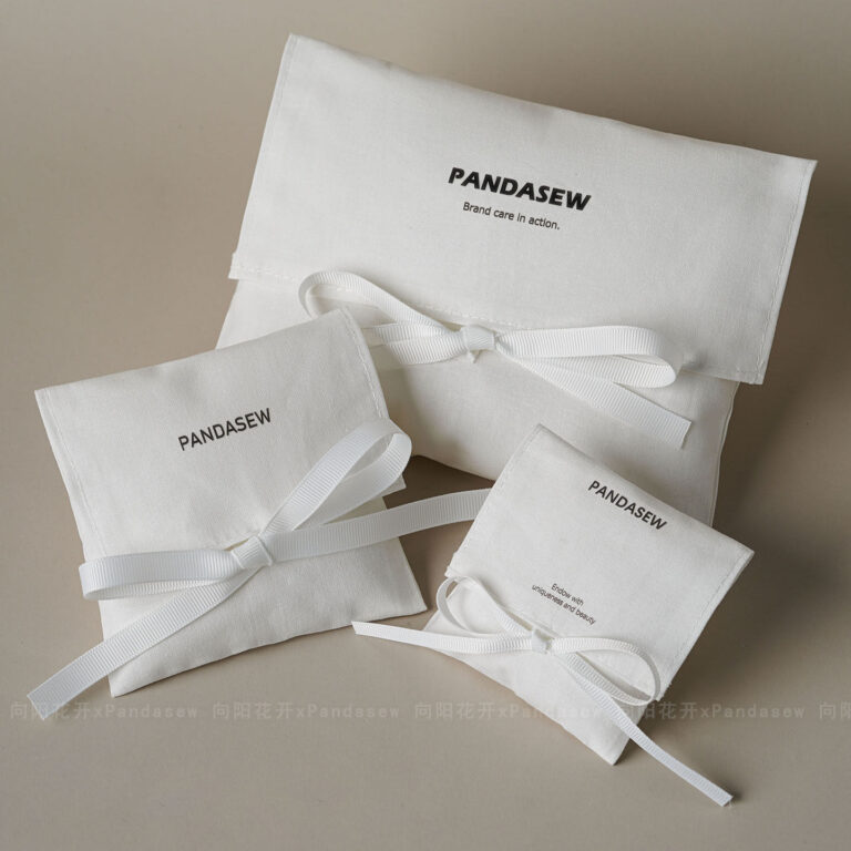 This custom white cotton pouch features a clean design and a soft drawstring closure. It provides an organic storage solution for jewelry branding.