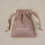 This custom faux sheepskin pouch features a soft suede texture and a vibrant finish. It provides an elegant storage solution for jewelry branding.