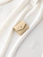 This custom folding jewelry pouch features a snap button and organized interior. It provides an elegant storage solution for jewelry branding.