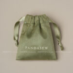 This custom faux sheepskin pouch features a soft suede texture and a vibrant finish. It provides an elegant storage solution for jewelry branding.