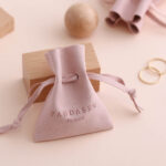 This custom microfiber ingot pouch features a unique ingot shape. It provides a soft, elegant, and secure storage solution for professional jewelry branding with a 100pc MOQ.