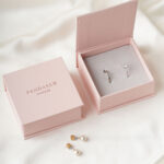 This custom book jewelry box features a unique book shape and a magnetic closure. It provides a secure and elegant solution for jewelry branding.