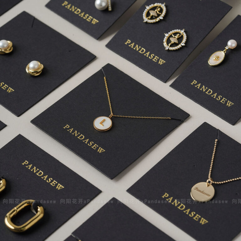 This custom black jewelry card features a rigid paperboard structure and precise cut-outs. It provides a professional display solution for jewelry.