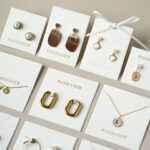 This custom white jewelry card features a soft cotton-textured structure and precise cut-outs. It provides a professional display solution for jewelry.