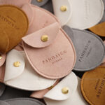 Custom microfiber saddle pouch made from premium soft suede. It is designed for jewelry brands seeking unique, secure, and professional packaging solutions with a curved saddle shape.