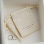 This custom cotton jewelry pouch features a soft starry fabric and a secure drawstring. It provides an organic storage solution for jewelry branding.