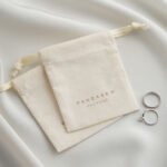 This custom cotton jewelry pouch features a soft starry fabric and a secure drawstring. It provides an organic storage solution for jewelry branding.