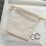 This custom cotton jewelry pouch features a soft starry fabric and a secure drawstring. It provides an organic storage solution for jewelry branding.