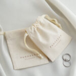 This custom cotton jewelry pouch features a soft starry fabric and a secure drawstring. It provides an organic storage solution for jewelry branding.