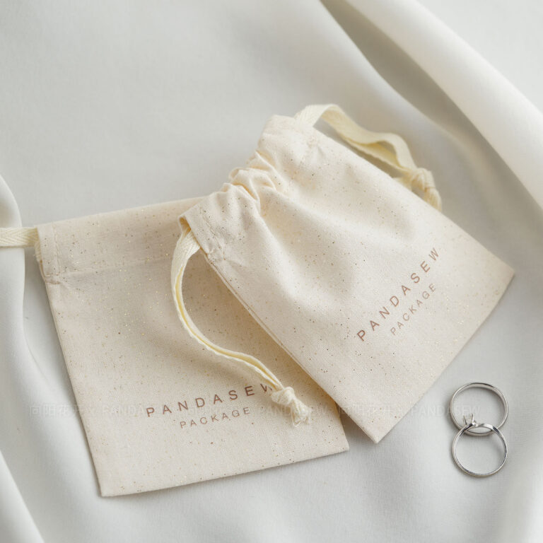 This custom cotton jewelry pouch features a soft starry fabric and a secure drawstring. It provides an organic storage solution for jewelry branding.