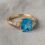 custom 10K yellow gold blue topaz engagement ring — custom jewelry manufacturing photo 1