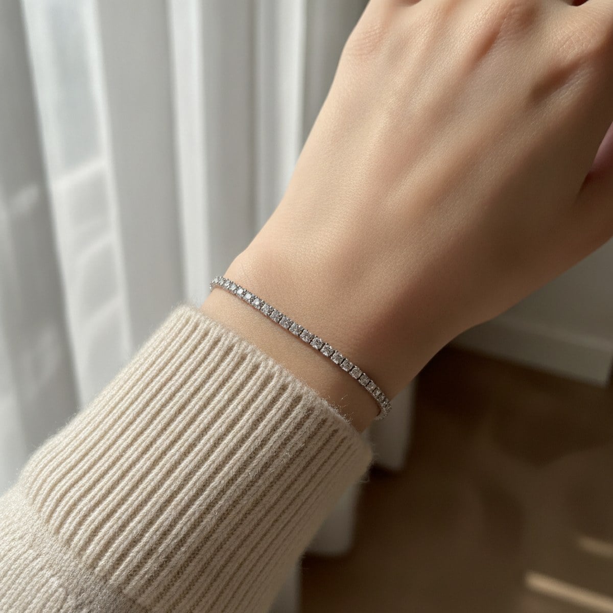 Slim white-gold diamond tennis bracelet on wrist — Alpha Jewelry OEM